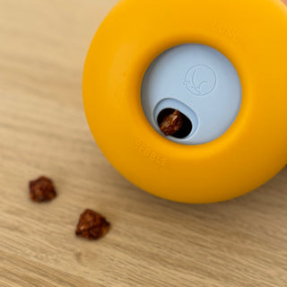 Citrine Yellow Slow Feeder Dog Toy with treats sticking out