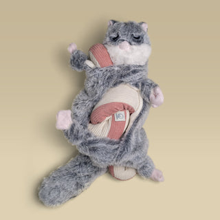 Flying squirrel Hugaboo snuffle toy wrapped around a pink Udon snuffle toy.